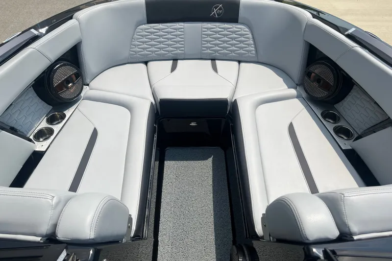 Slide: The Image of 2023 MasterCraft X24 boat interior with luxurious seating and built-in speakers. - 12