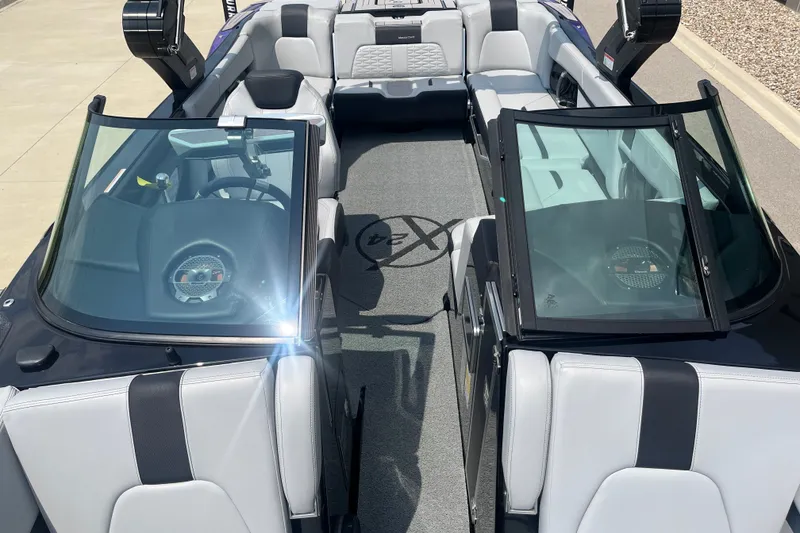 Slide: The Image of 2023 MasterCraft X24 boat interior with sleek seating and modern dashboard design. - 13