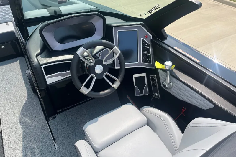 Slide: The Image of 2023 MasterCraft X24 boat cockpit with modern steering wheel and digital controls. - 10