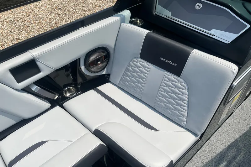 Slide: The Image of 2023 MasterCraft X24 boat interior with stylish seating and premium audio system. - 11