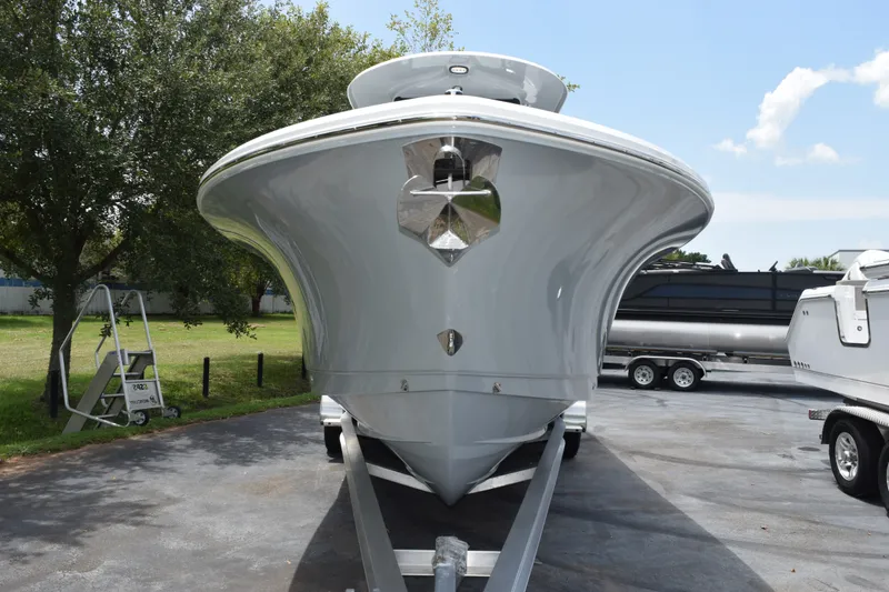 Slide: The Image of Front view of a 2027 Sea Hunt Gamefish 25 boat on a trailer, parked outdoors. - 3