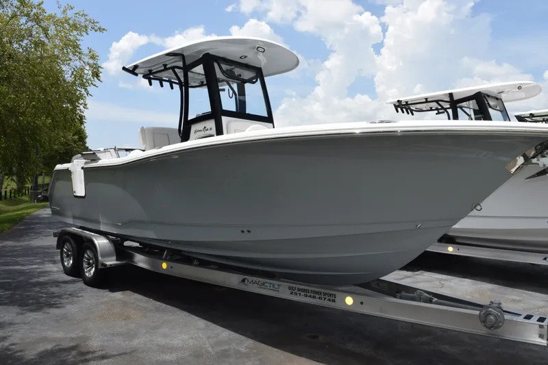 Slide: The Image of 2027 Sea Hunt Gamefish 25 boat on trailer, sleek design under a clear sky. - 2