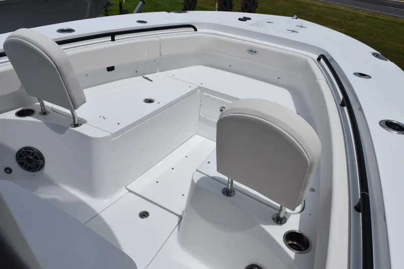 Slide: The Image of 2027 Sea Hunt Gamefish 25 boat interior with white seating and storage compartments. - 8