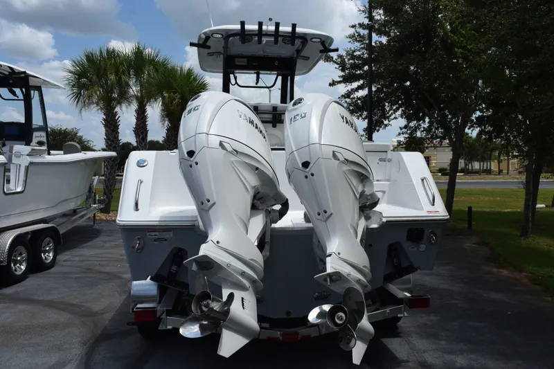 Slide: The Image of 2027 Sea Hunt Gamefish 25 with dual Yamaha outboard motors, parked outdoors. - 5