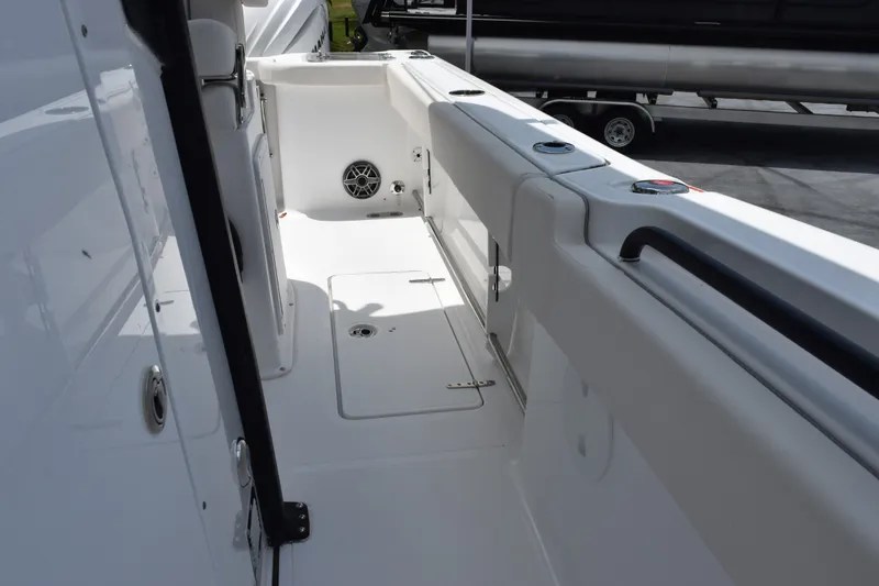 Slide: The Image of Interior view of 2027 Sea Hunt Gamefish 25 boat, featuring sleek white design and storage compartments. - 11