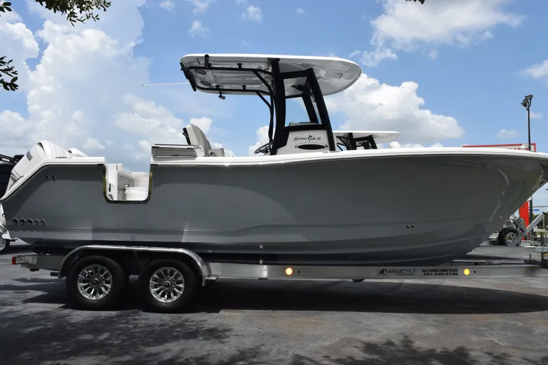 The Image of 2027 Sea Hunt Gamefish 25 boat on trailer under cloudy sky. - 1