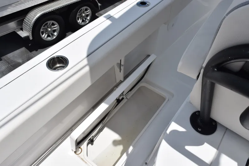Slide: The Image of 2027 Sea Hunt Gamefish 25 boat interior with storage compartment and cup holder. - 12