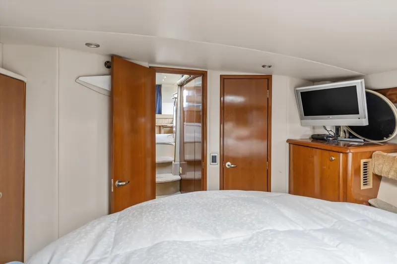 Slide: The Image of Interior of 2006 Meridian 411 Sedan yacht bedroom with TV and wooden cabinetry. - 16