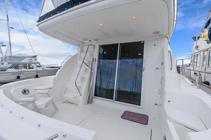 Slide: The Image of 2006 Meridian 411 Sedan yacht deck with seating and sliding glass doors. - 7