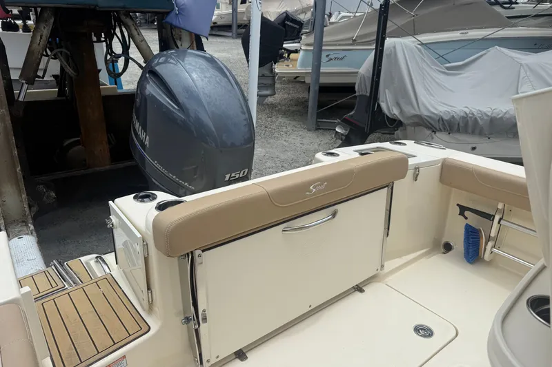 Slide: The Image of 2024 Scout 215 XSF boat with Yamaha 150 engine, docked in a marina. - 3