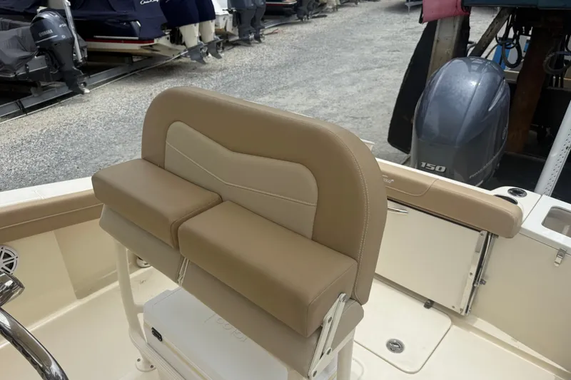 Slide: The Image of 2024 Scout 215 XSF boat interior with tan seating and Yamaha 150 outboard motor. - 8