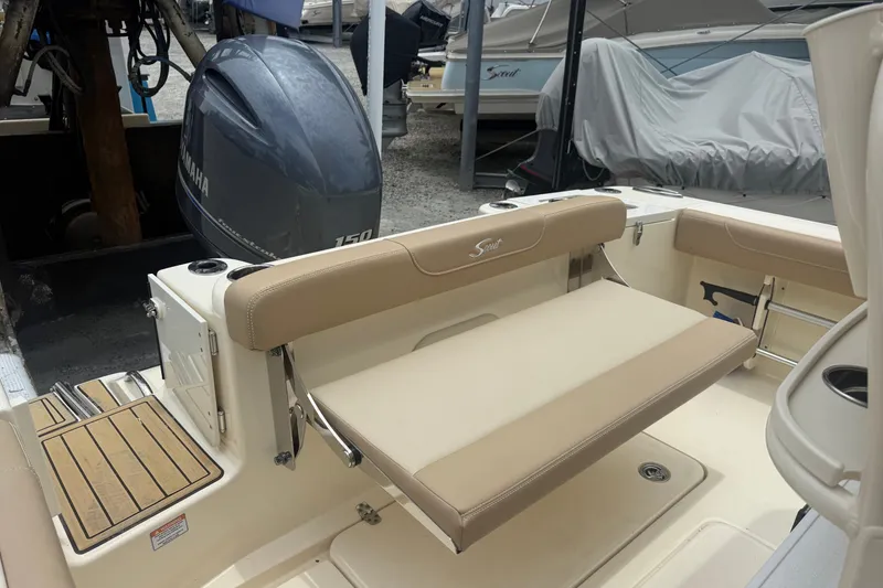 Slide: The Image of 2024 Scout 215 XSF boat interior with Yamaha 150 engine, featuring beige seating. - 4