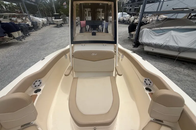 Slide: The Image of 2024 Scout 215 XSF boat interior with beige seating and cup holders. - 12