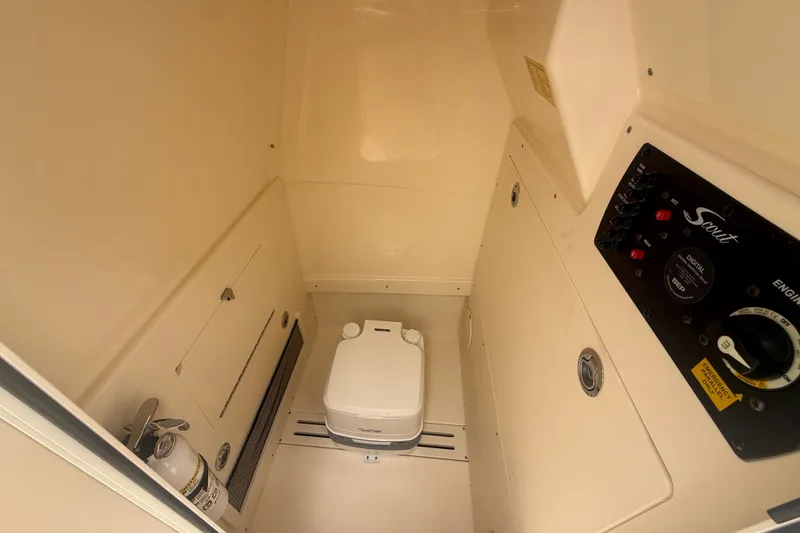 Slide: The Image of 2024 Scout 215 XSF boat interior with toilet and control panel. - 14