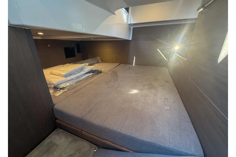Slide: The Image of Interior cabin of 2026 Beneteau Flyer 10 Sport Top with cozy bedding. - 20