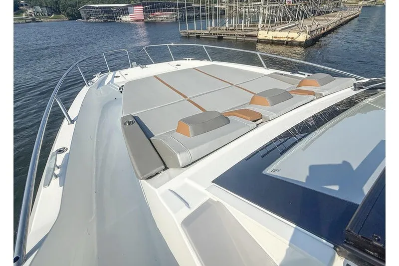 Slide: The Image of 2026 Beneteau Flyer 10 Sport Top boat with spacious sun deck on calm water. - 21