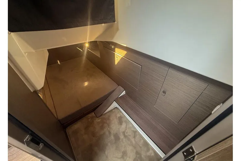 Slide: The Image of Interior cabin of 2026 Beneteau Flyer 10 Sport Top, featuring modern wood paneling. - 19