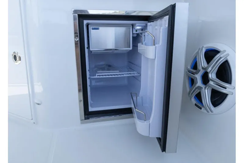 Slide: The Image of Open mini fridge on 2026 Beneteau Flyer 10 Sport Top boat, showcasing interior storage. - 9