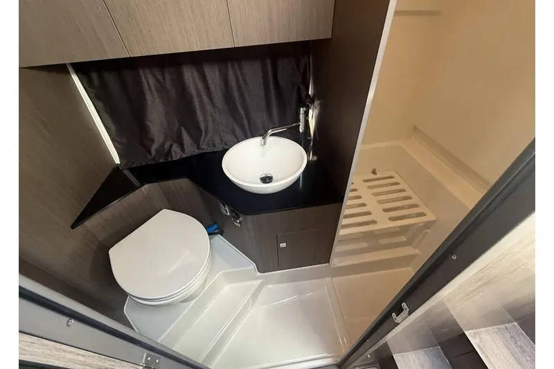 Slide: The Image of 2026 Beneteau Flyer 10 Sport Top bathroom with modern sink, toilet, and shower. - 17