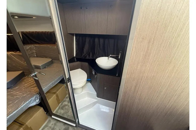 Slide: The Image of 2026 Beneteau Flyer 10 Sport Top interior bathroom with modern sink and toilet. - 16