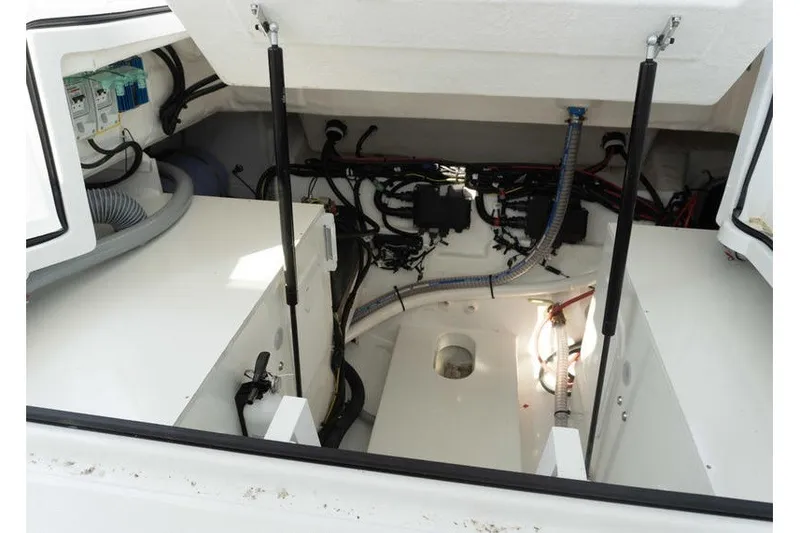 Slide: The Image of Engine compartment of 2026 Beneteau Flyer 10 Sport Top, showcasing wiring and components. - 29