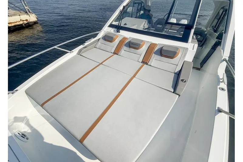 Slide: The Image of 2026 Beneteau Flyer 10 Sport Top with spacious sunbathing deck on calm waters. - 23