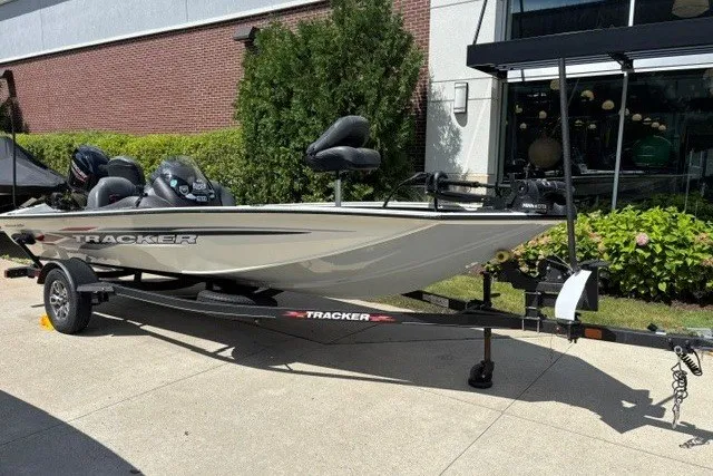 The Image of 2023 Tracker Pro Team 175 TXW Tournament Edition boat on trailer, parked outdoors. - 0