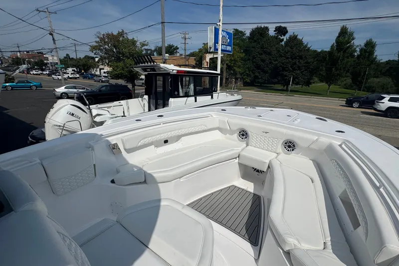 Slide: The Image of 2027 Tidewater 272 LXF boat with spacious seating and Yamaha engine in a marina setting. - 25