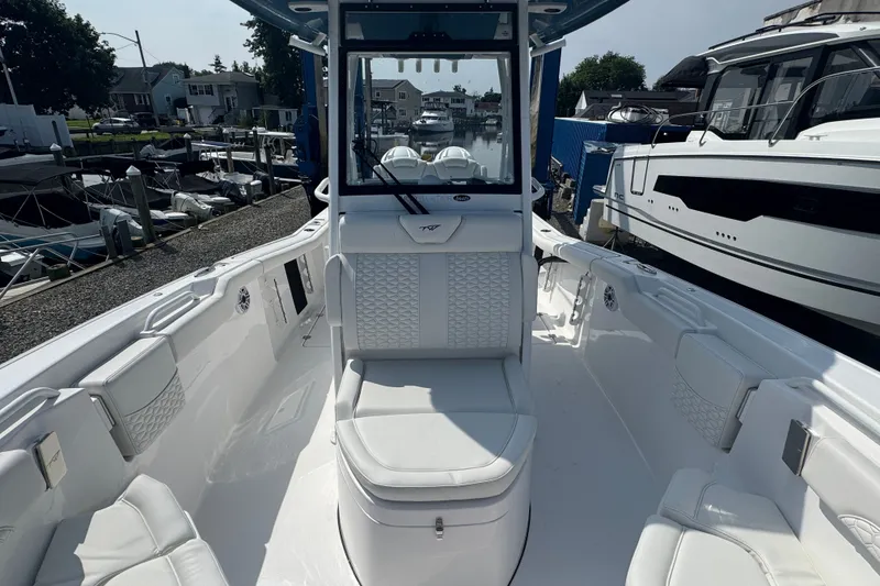 Slide: The Image of 2027 Tidewater 272 LXF boat interior with white seating and modern design. - 21