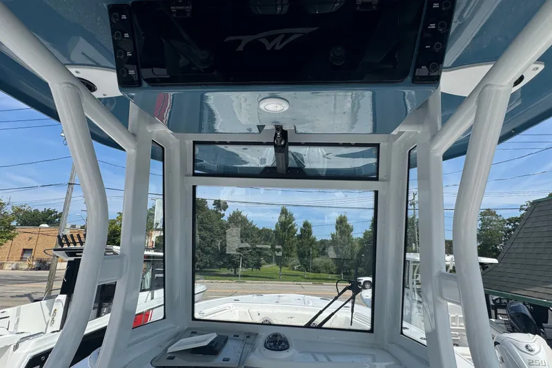 Slide: The Image of Interior view of a 2027 Tidewater 272 LXF boat, showcasing helm and windshield. - 16