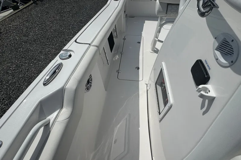 Slide: The Image of 2027 Tidewater 272 LXF boat interior, featuring sleek white design and modern amenities. - 23