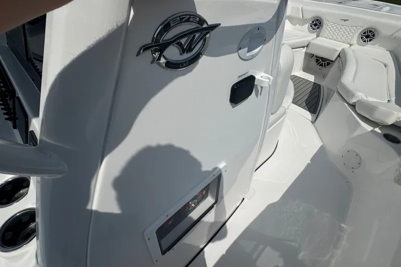Slide: The Image of 2027 Tidewater 272 LXF boat interior with seating and logo detail. - 24
