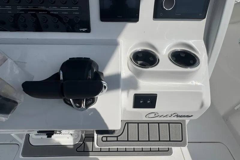 Slide: The Image of Control panel of 2027 Tidewater 272 LXF boat with dual cup holders. - 14