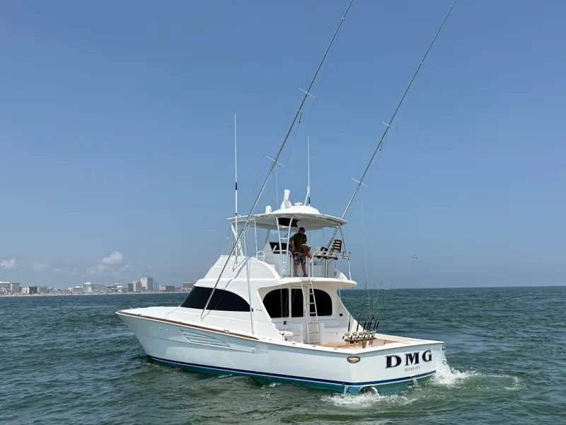 Slide: The Image of A white fishing boat with two long fishing rods sails on the sea. The coastline is visible in the background. - 3