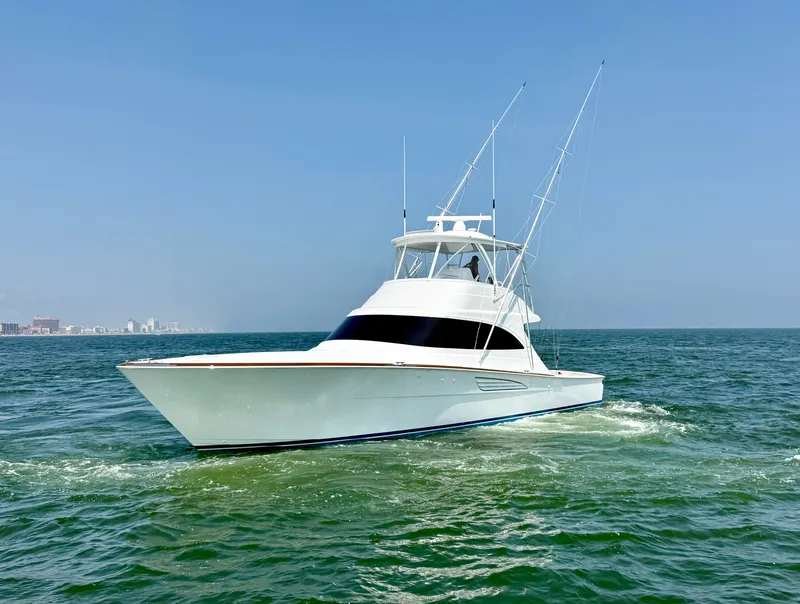 Slide: The Image of The 2027 Viking 50 Billfish cruises on calm waters with a clear skyline in the background. - 6