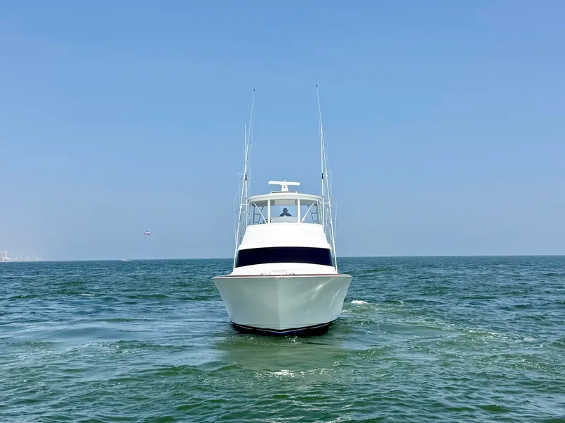 Slide: The Image of The 2027 Viking 50 Billfish cruising on open water under a clear sky. - 7