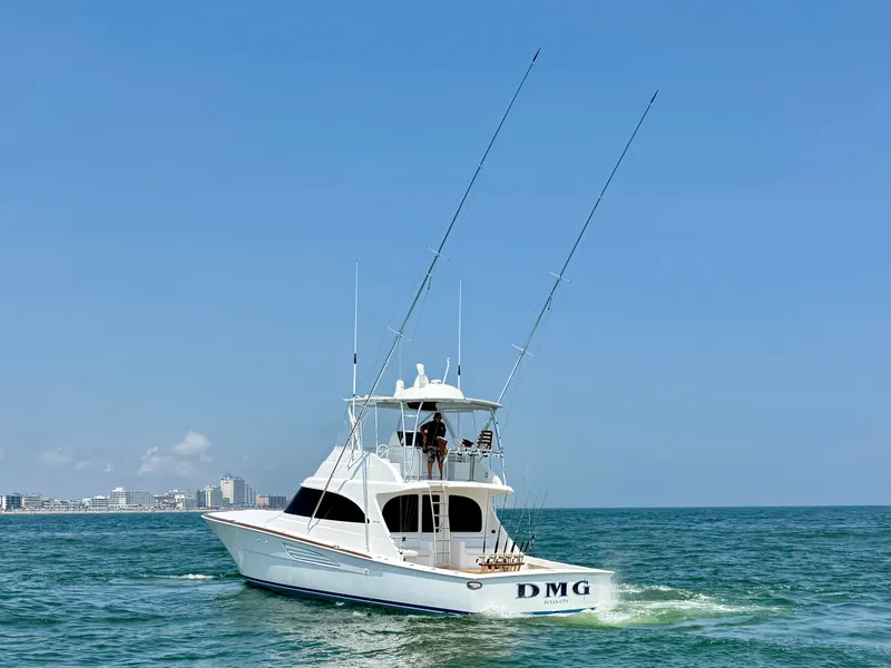 Slide: The Image of A white fishing boat with two tall antennas navigates the sea. Buildings are visible in the background. - 4
