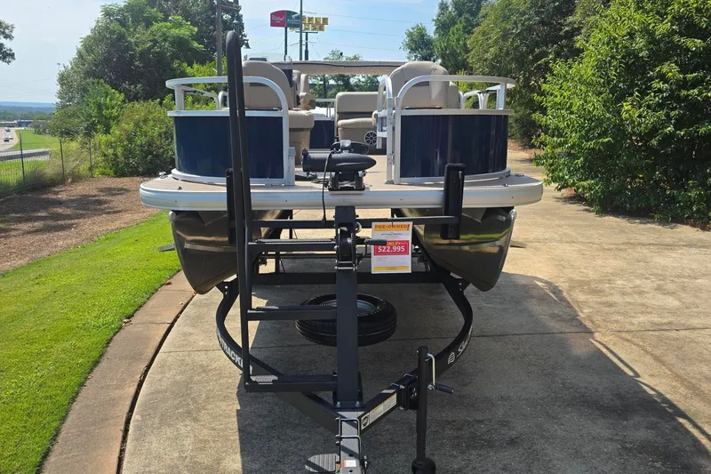 Slide: The Image of 2025 Sun Tracker Bass Buggy 16 XL Select pontoon boat on trailer, pre-owned for $22,995. - 13