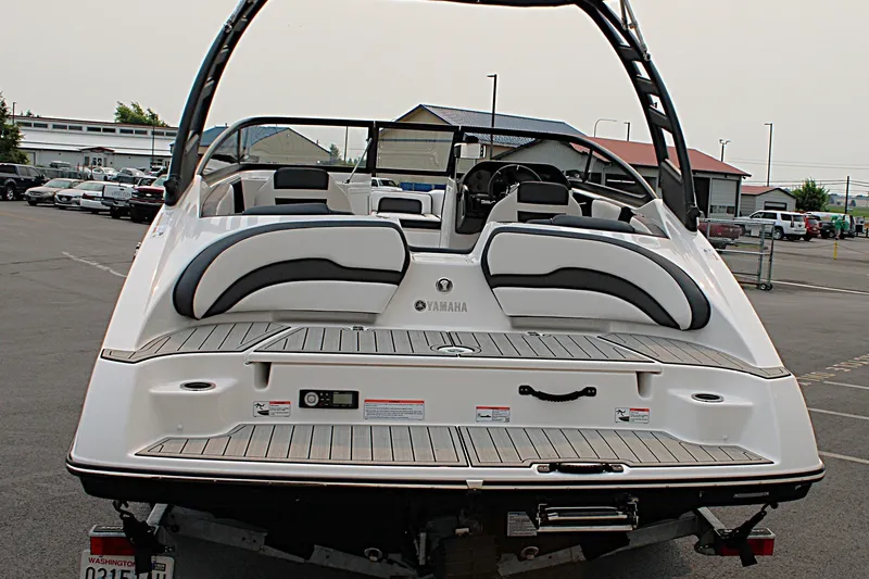 Slide: The Image of 2022 Yamaha Boats 195S, rear view in a parking lot, showcasing sleek design. - 5