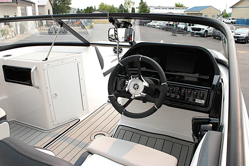 Slide: The Image of 2022 Yamaha Boats 195S cockpit with steering wheel and control panel. - 11
