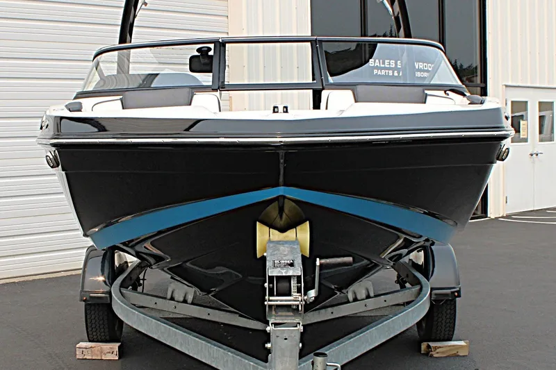 Slide: The Image of 2022 Yamaha Boats 195S on trailer, front view, parked outside a building. - 9