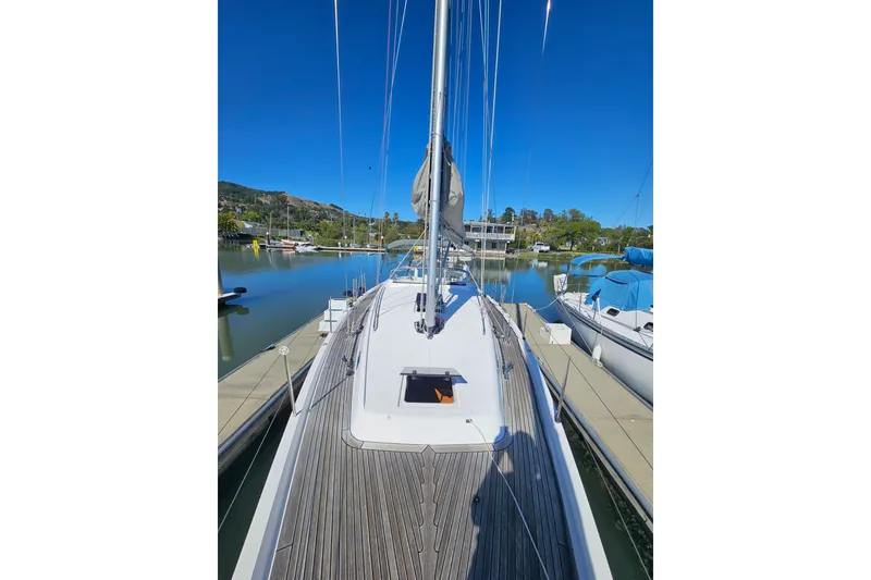 Slide: The Image of 2015 X-Yachts Xc 38 sailboat docked in a serene marina setting. - 4