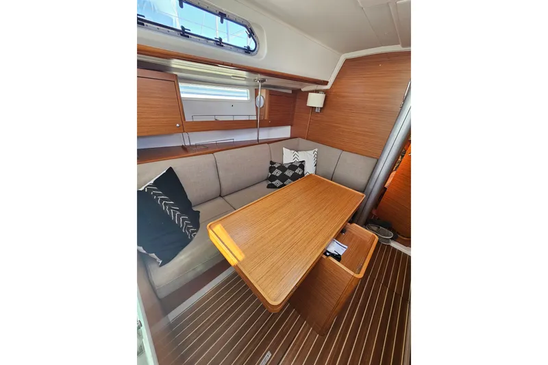 Slide: The Image of Interior of 2015 X-Yachts Xc 38 sailboat with wooden table and cushioned seating. - 15