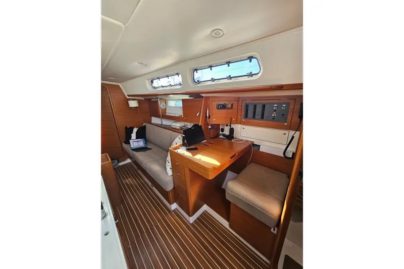 Slide: The Image of Interior of 2015 X-Yachts Xc 38 sailboat with wooden furnishings and navigation station. - 9