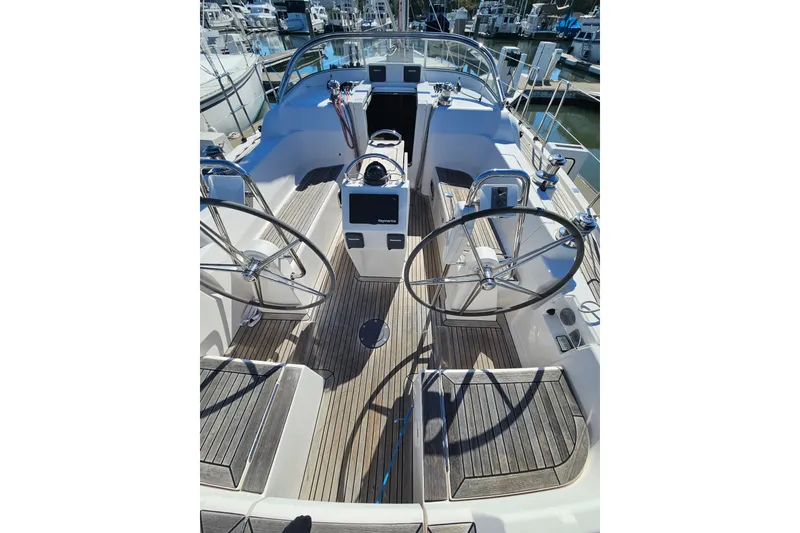 Slide: The Image of Cockpit of 2015 X-Yachts Xc 38 sailboat with dual steering wheels and teak decking. - 2