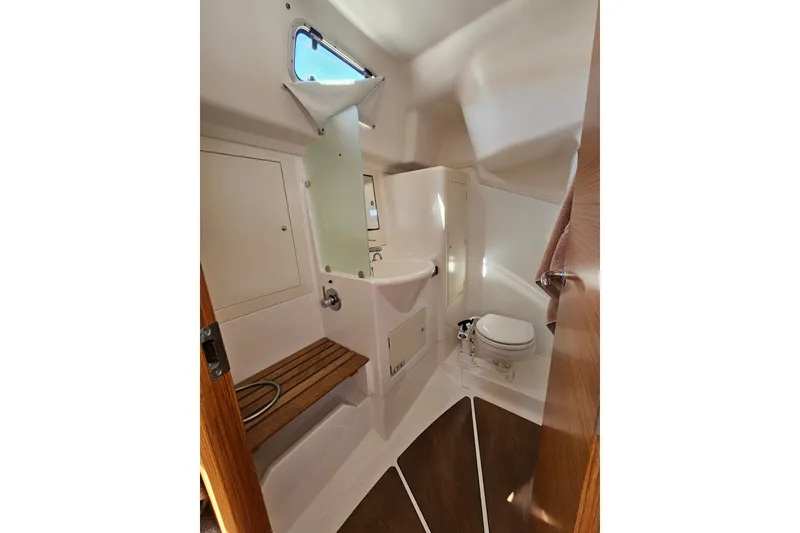 Slide: The Image of 2015 X-Yachts Xc 38 yacht bathroom with wooden accents and compact design. - 10