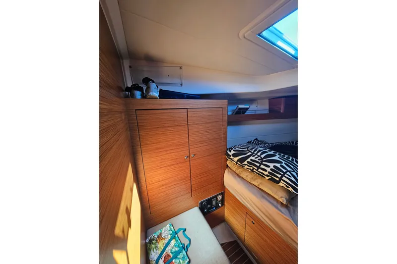 Slide: The Image of Cozy cabin interior of 2015 X-Yachts Xc 38 with wooden cabinetry and patterned bedding. - 14