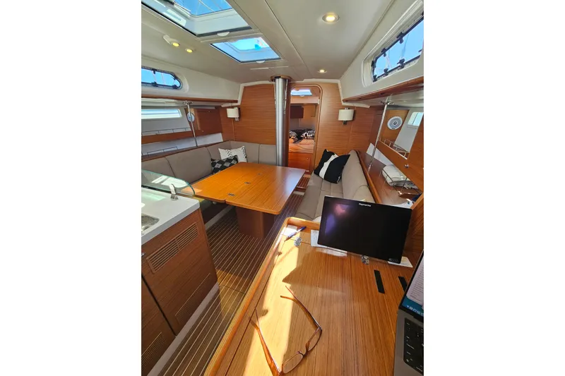 Slide: The Image of Interior of 2015 X-Yachts Xc 38 sailboat with wooden furnishings and skylights. - 16