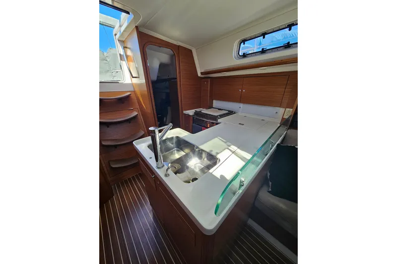 Slide: The Image of Modern galley kitchen in 2015 X-Yachts Xc 38 sailboat with wood cabinetry and sleek design. - 8