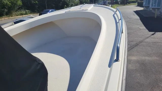 Slide: The Image of A 2004 Parker 23 Special Edition boat with an open bow deck and railing. - 8